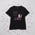 Black women’s t-shirt with a lilac pill bottle, glittery pink lipstick and pink lettering reading maybe she’s born with it, maybe it’s sertraline