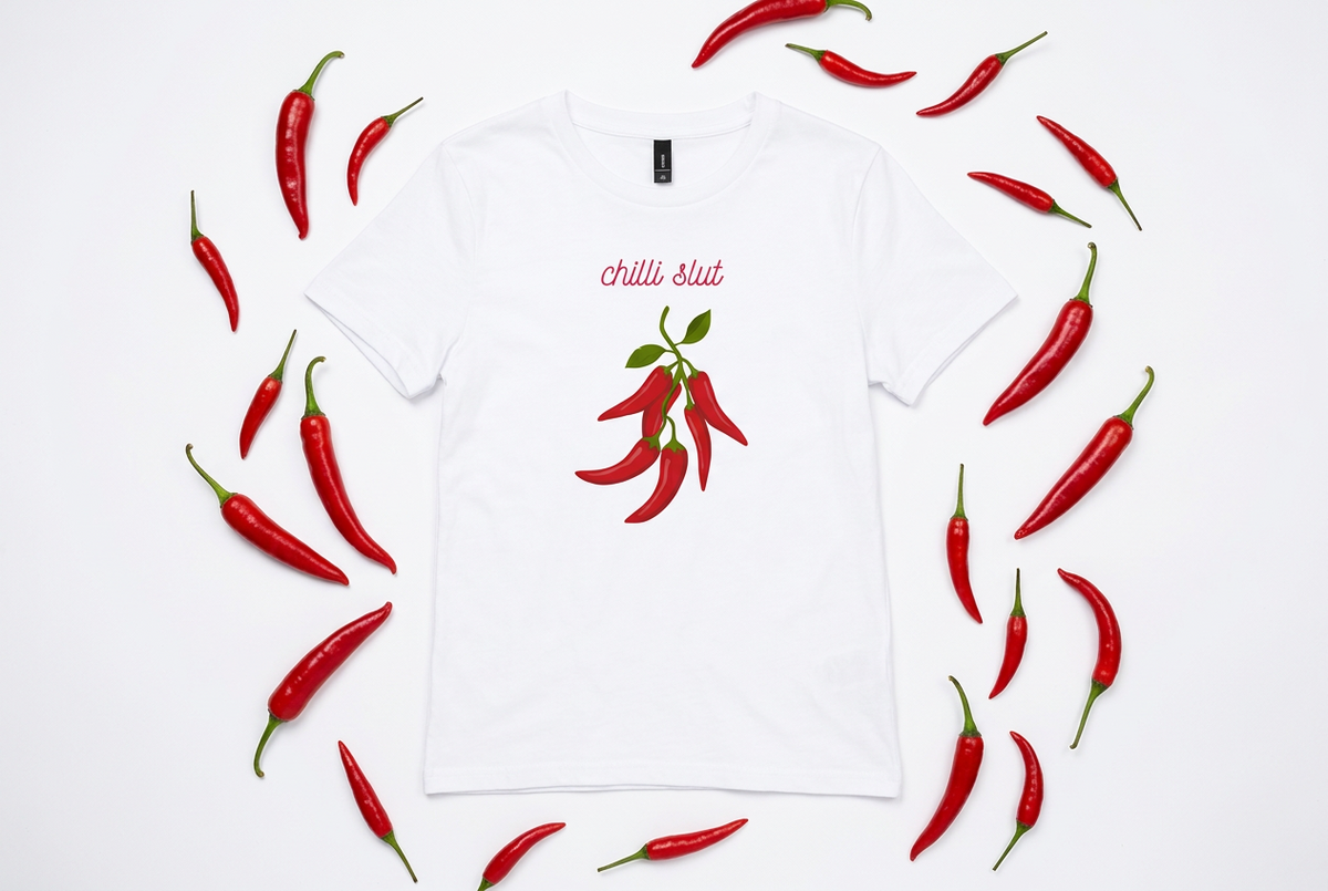 White women’s t-shirt with a red chilli illustration and “chilli slut” text in pink script